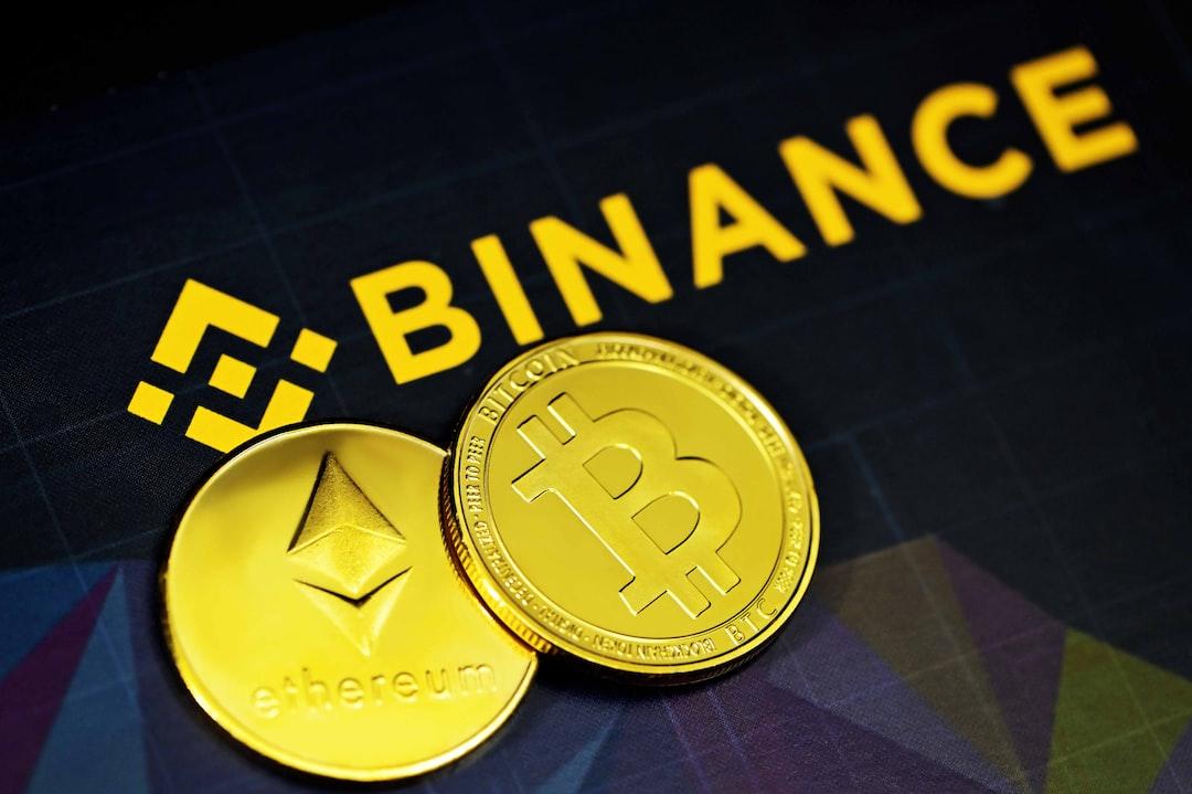 two gold bitcoins sitting next to a binance sign - Ethereum and Bitcoin next to the Binance logo, tags: withdrawals due - unsplash