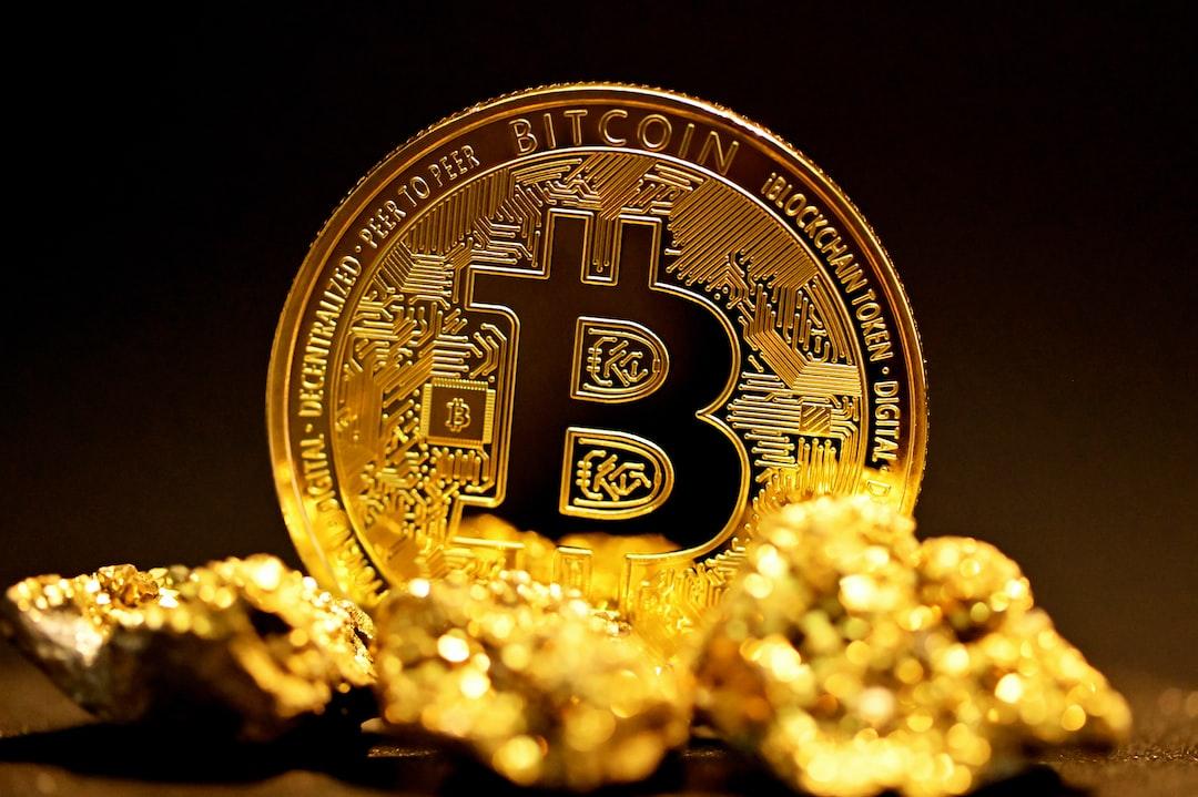 a bitcoin sitting on top of a pile of gold nuggets - A single bitcoin surrounded by raw gold pieces., tags: transaction fees attack - unsplash